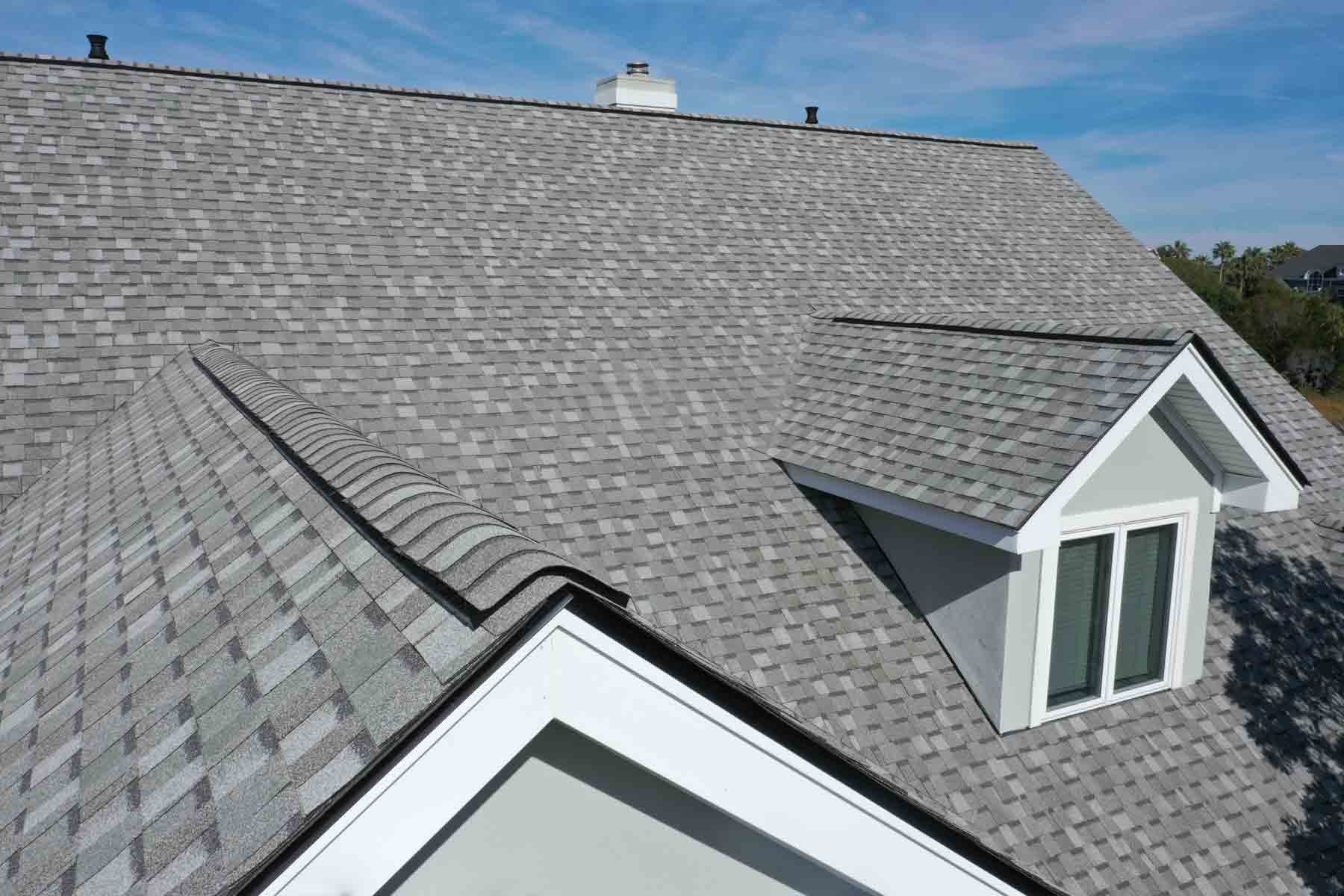 Aerial view of a residential asphalt shingle roof, coated and sealed